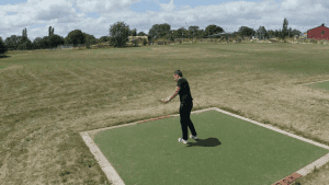 Guy swinging at the golf park