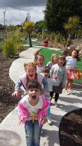 Excited kids enjoying the golf park