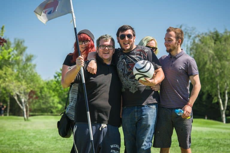Laughing group with footgolf balls on the course