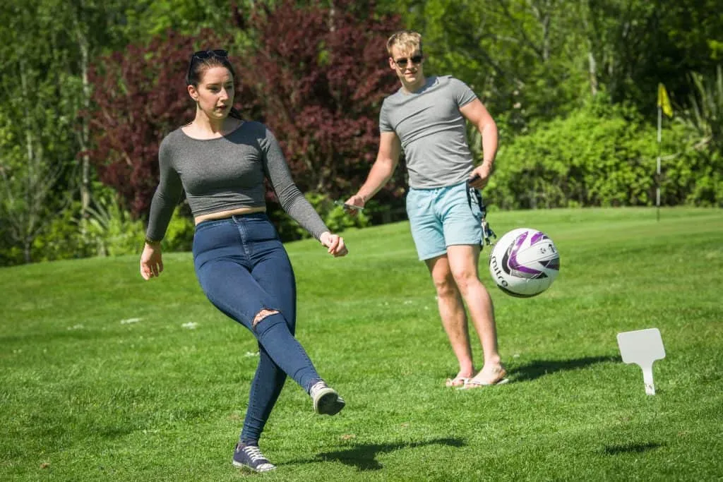 Woman kicking a golf ball