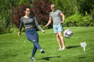 Woman kicking a golf ball