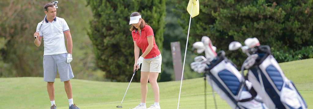 Lady making a shot at the golf park.