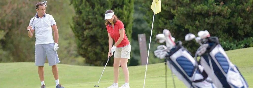 Lady making a shot at the golf park.