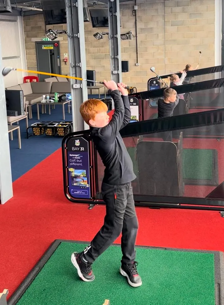 Young golfers mastering swings at a learning facility