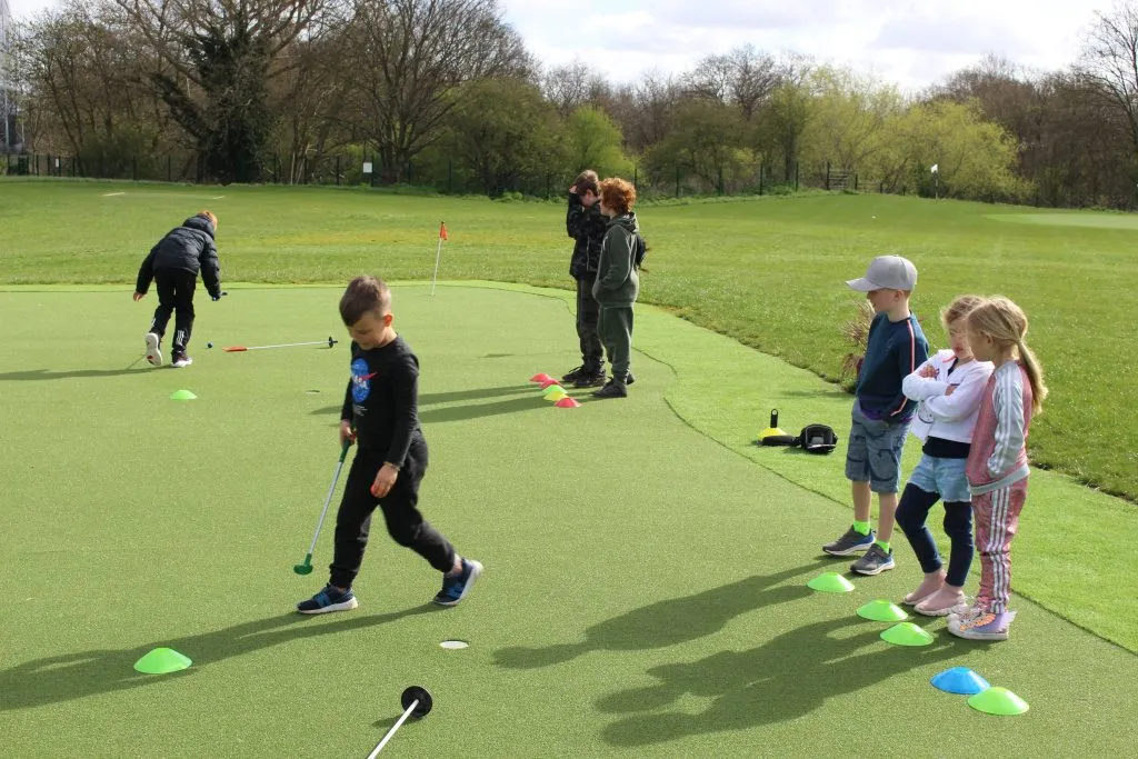 Kids playing mini golf