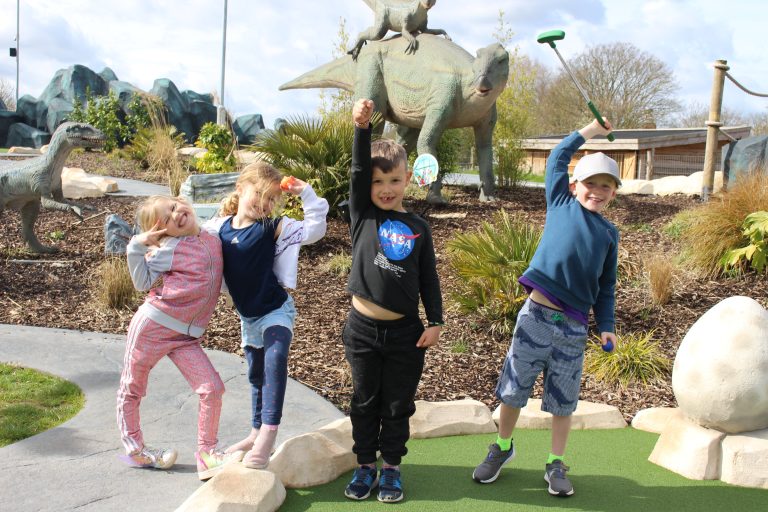 Children posing at Volcano Island Adventure Golf.