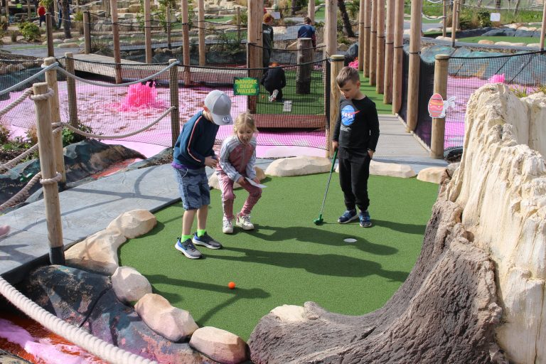 Children enjoying golf on a mini course.