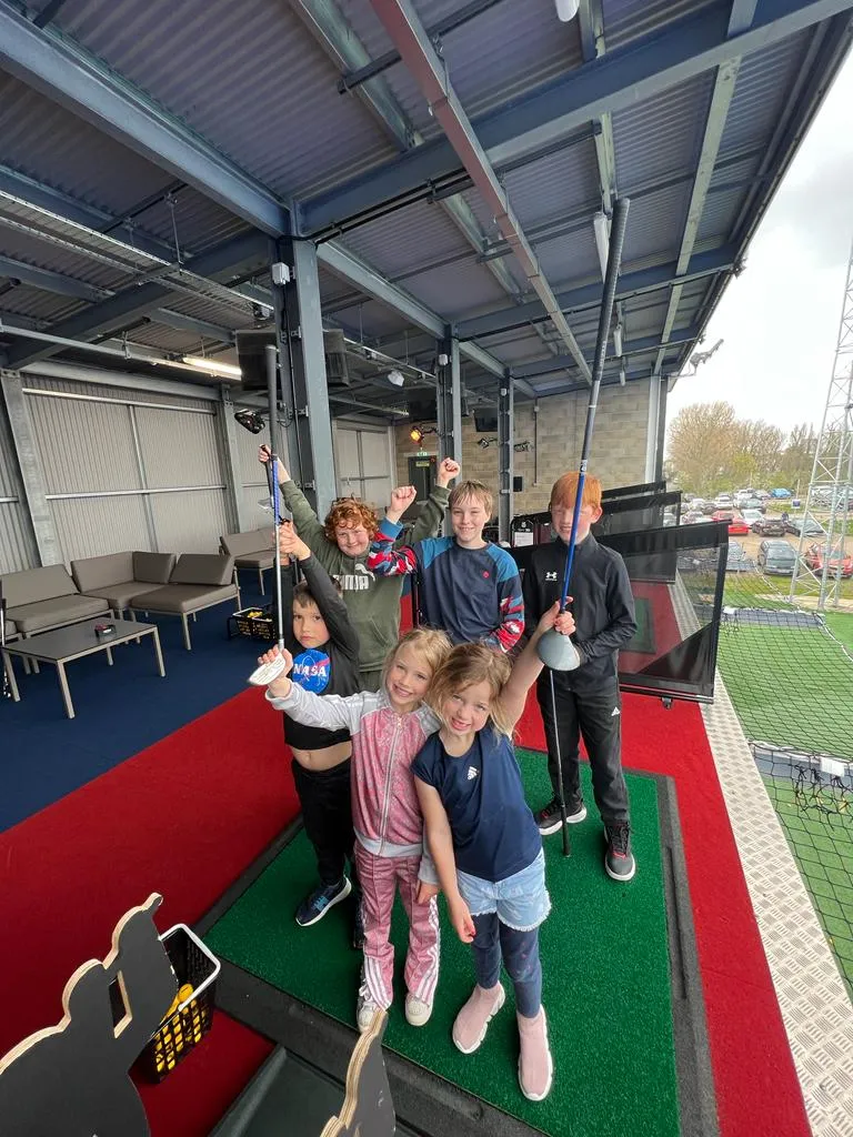Young golf enthusiasts at a learning facility